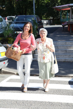 caregiver accompanying elderly woman on shopping